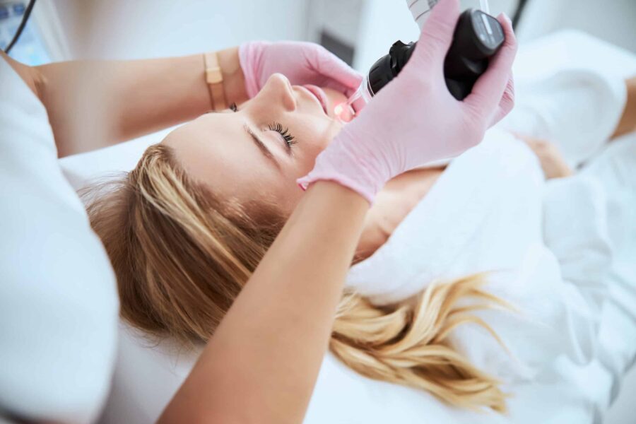 Woman receiving the fractional laser treatment in a beauty salon