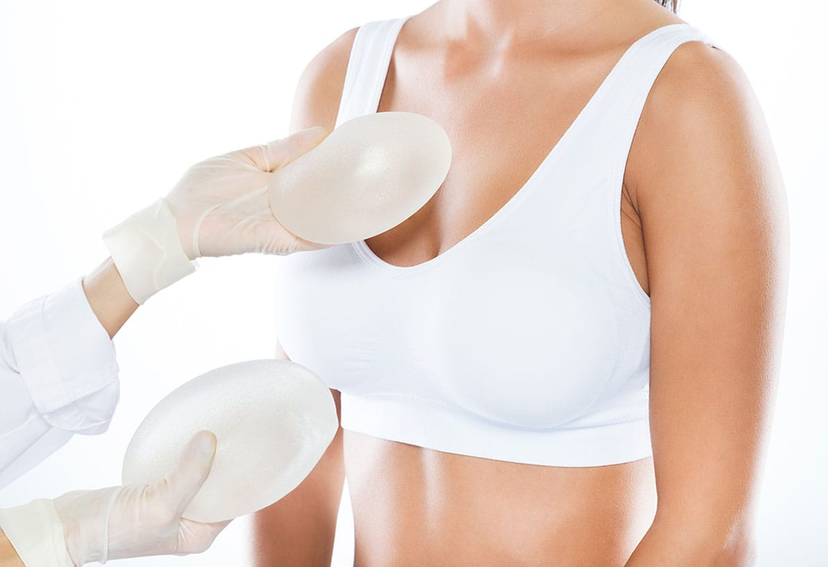 woman choosing between saline and silicone breast implants in Williamsburg, VA